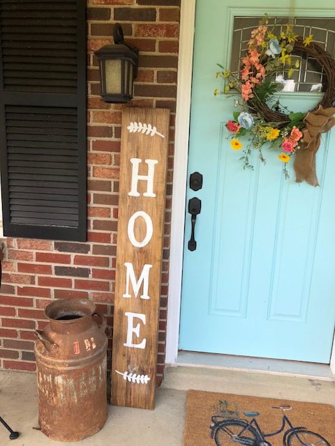 Decorating your front porch is a great way to welcome guests in. It's also the first thing you see when you pull in the drive. So, why not make it pretty with a DIY front porch home sign. I'll show you how to make one under $10!