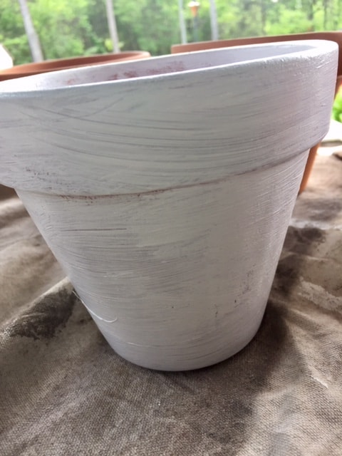 A great spring DIY project! Painted terra cotta flower pots are an easy way to update your home and garden for spring on a budget!