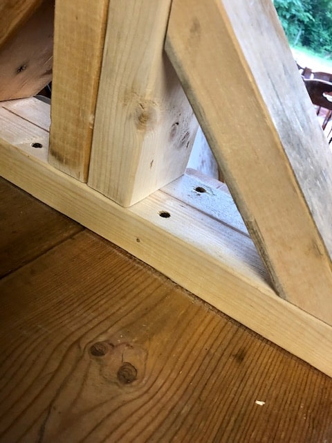 Make this farmhouse DIY dining room bench for under $20! Perfect for small spaces, front porches, and to add extra seating with storage underneath. 