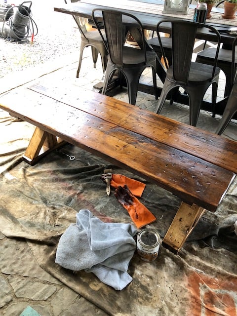 Make this farmhouse DIY dining room bench for under $20! Perfect for small spaces, front porches, and to add extra seating with storage underneath. 