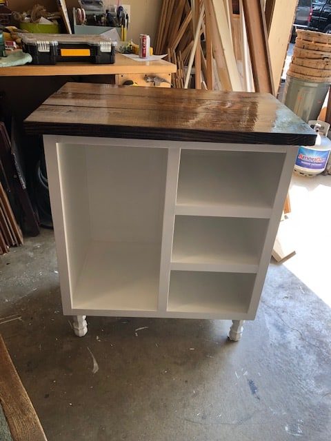 We made this DIY dog food station for dog food storage for food, treats, and toys. The pull out drawer is perfect for scooping dog food. Organize dog food