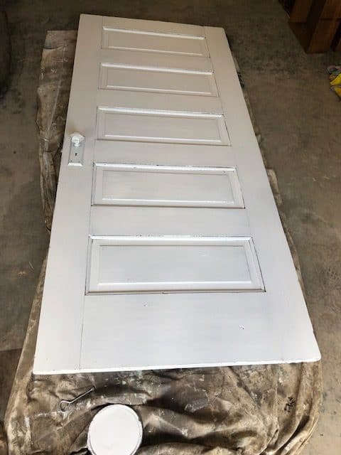 See how I made a DIY day bed on a budget with this tutorial. I used an old vintage door to create a headboard and built a wooden day bed frame.