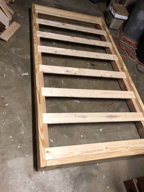See how I made a DIY day bed on a budget with this tutorial. I used an old vintage door to create a headboard and built a wooden day bed frame.