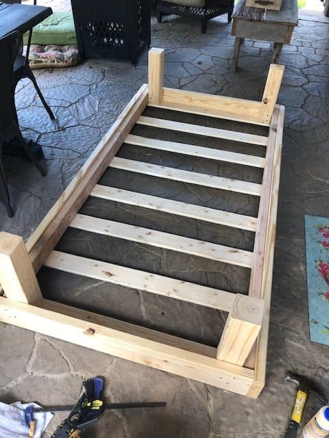 See how I made a DIY day bed on a budget with this tutorial. I used an old vintage door to create a headboard and built a wooden day bed frame.