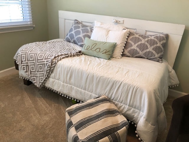 See how I made a DIY day bed on a budget with this tutorial. I used an old vintage door to create a headboard and built a wooden day bed frame.