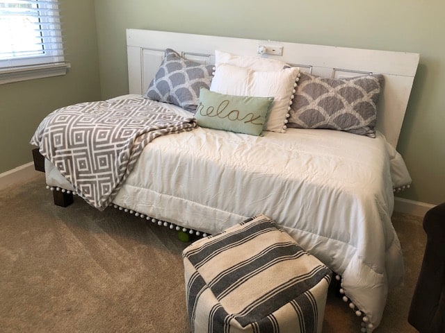 See how I made a DIY day bed on a budget with this tutorial. I used an old vintage door to create a headboard and built a wooden day bed frame.