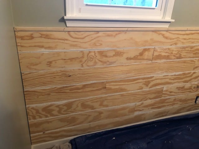 See how we made this easy and budget friendly DIY shiplap headboard wall for our bedroom makeover. Full materials list and step by step directions!