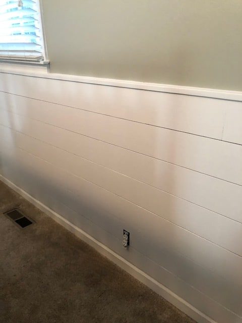 See how we made this easy and budget friendly DIY shiplap headboard wall for our bedroom makeover. Full materials list and step by step directions!