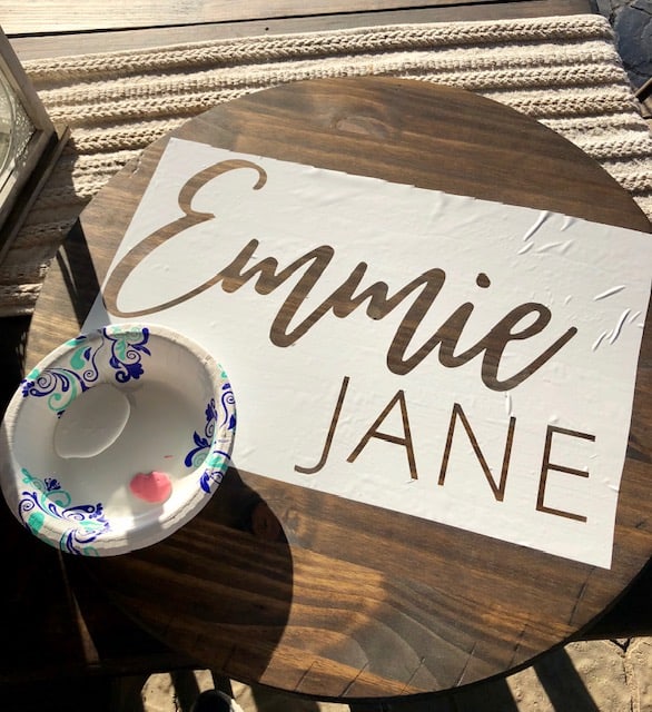 Step by step directions to make your own DIY circle name sign for a boy or girl nursery using a vinyl stencil, paint, and a wood board for under $15.