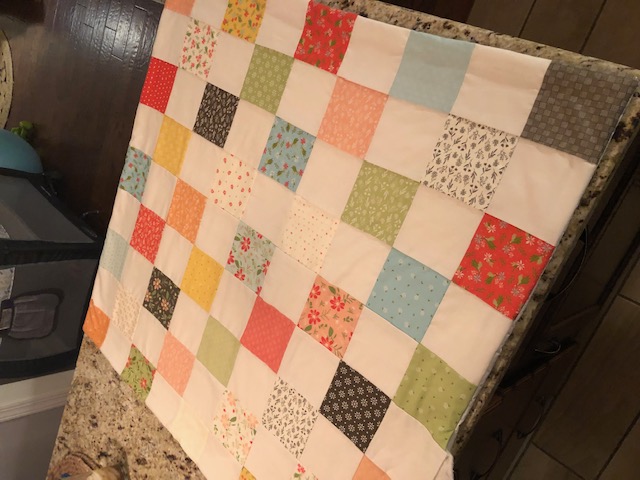 This beginner level DIY baby quilt was so fun and easy to make. You can make your own simple homemade baby quilt with pre cut squares, too.