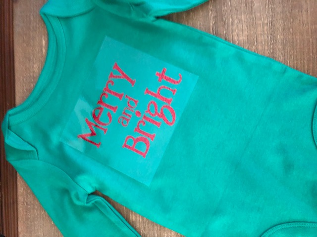 Make your own DIY Christmas bodysuits for baby with this easy beginner Cricut project. These simple iron on designs are quick to make and so cute!
