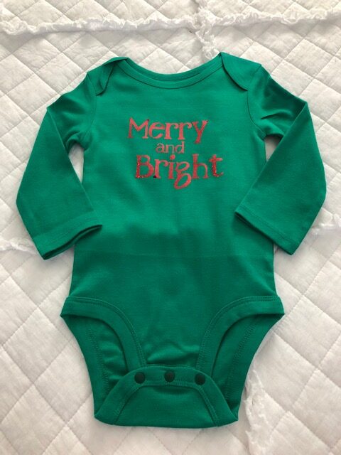 Make your own DIY Christmas bodysuits for baby with this easy beginner Cricut project. These simple iron on designs are quick to make and so cute!