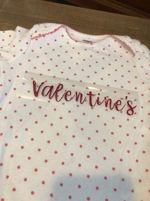 Make your own easy, quick, and frugal DIY Valentine's Day shirt for Baby with this step by step beginner Cricut iron on tutorial.